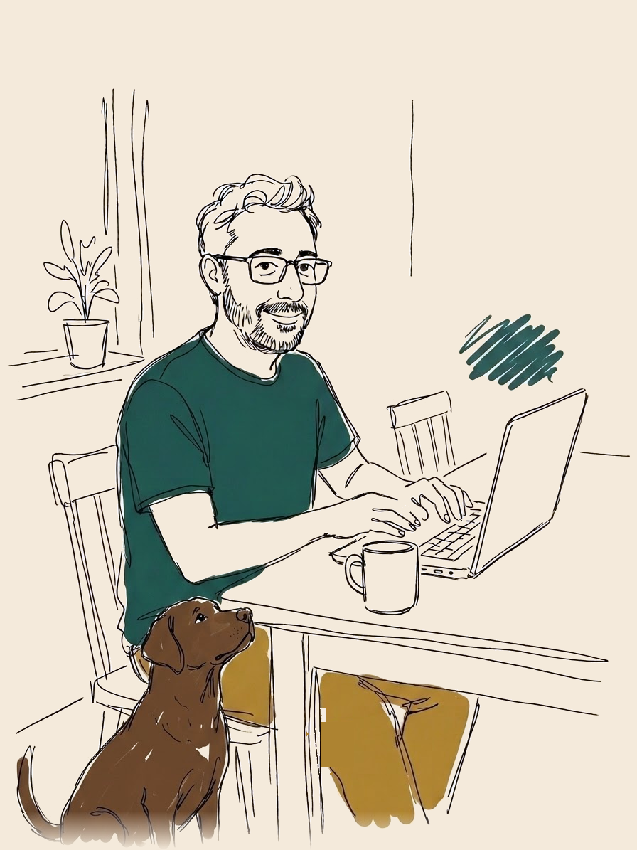 Paul working at his kitchen table with his dog beside him
